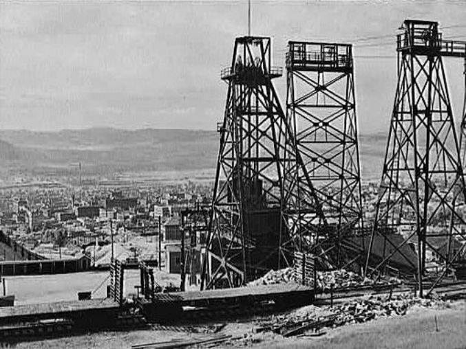 Anaconda Copper Mining Company mine headframes towering over Butte, Montana