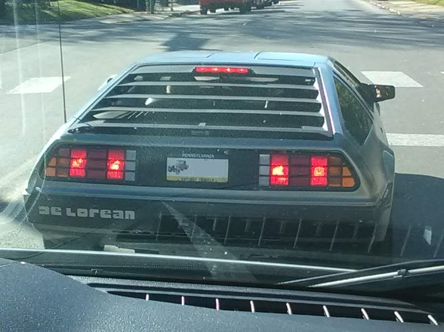 A 1981-1983 DeLorean DMC-12 showing its brushed stainless-steel body and wedge profile