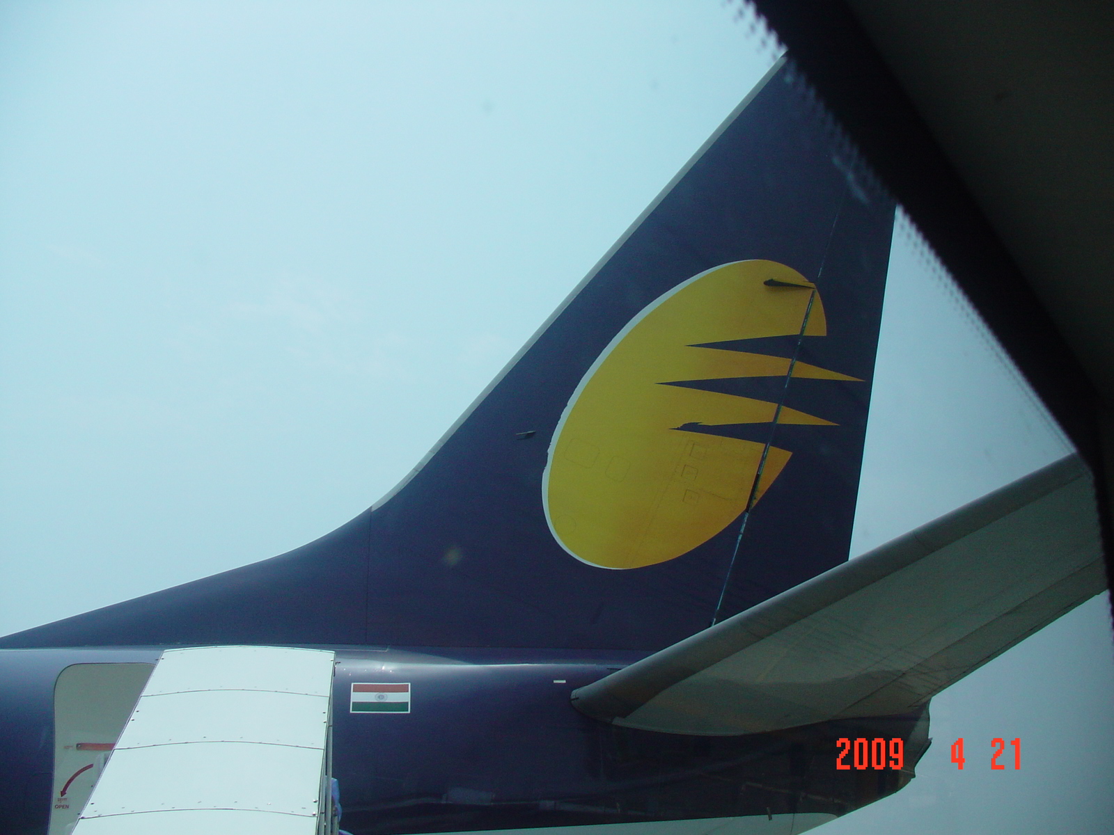 The tail of a Jet Airways Boeing 737-800 with the airline's flying-sun emblem