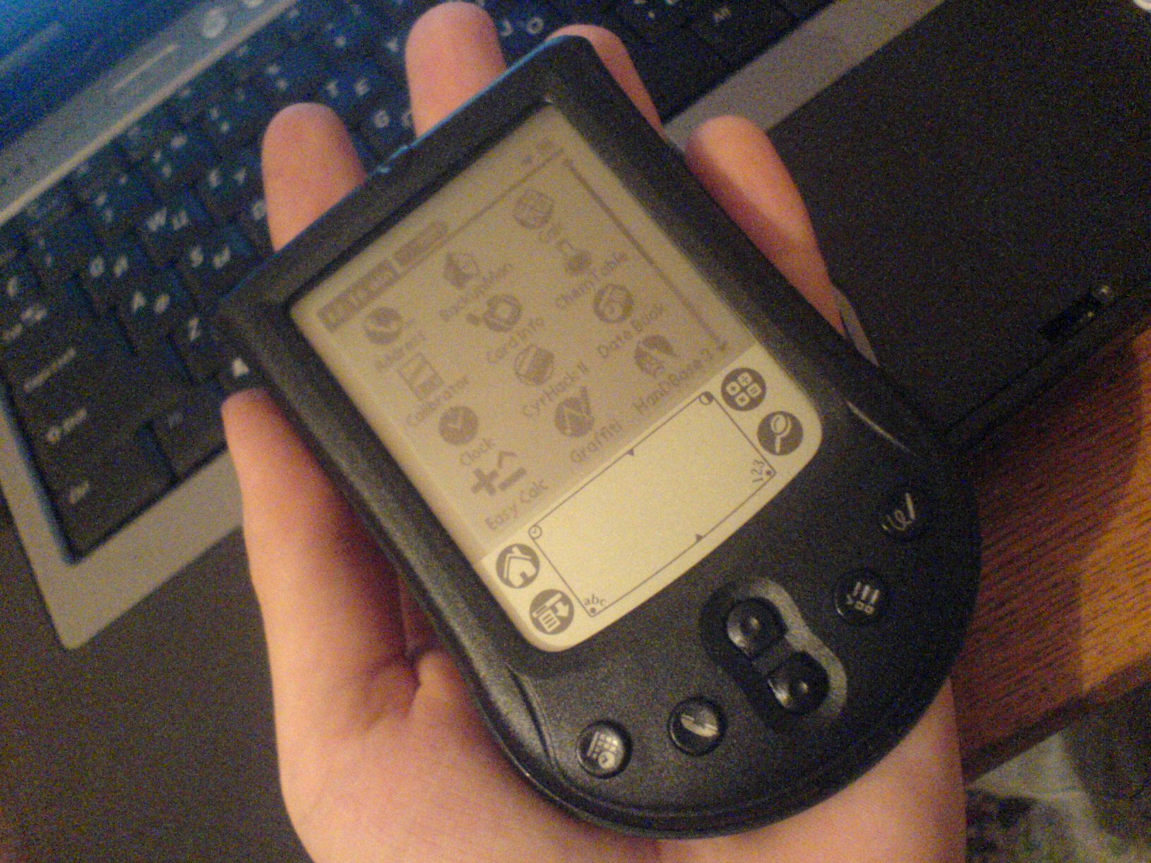 A Palm m125 personal digital assistant in hand, running Palm OS.