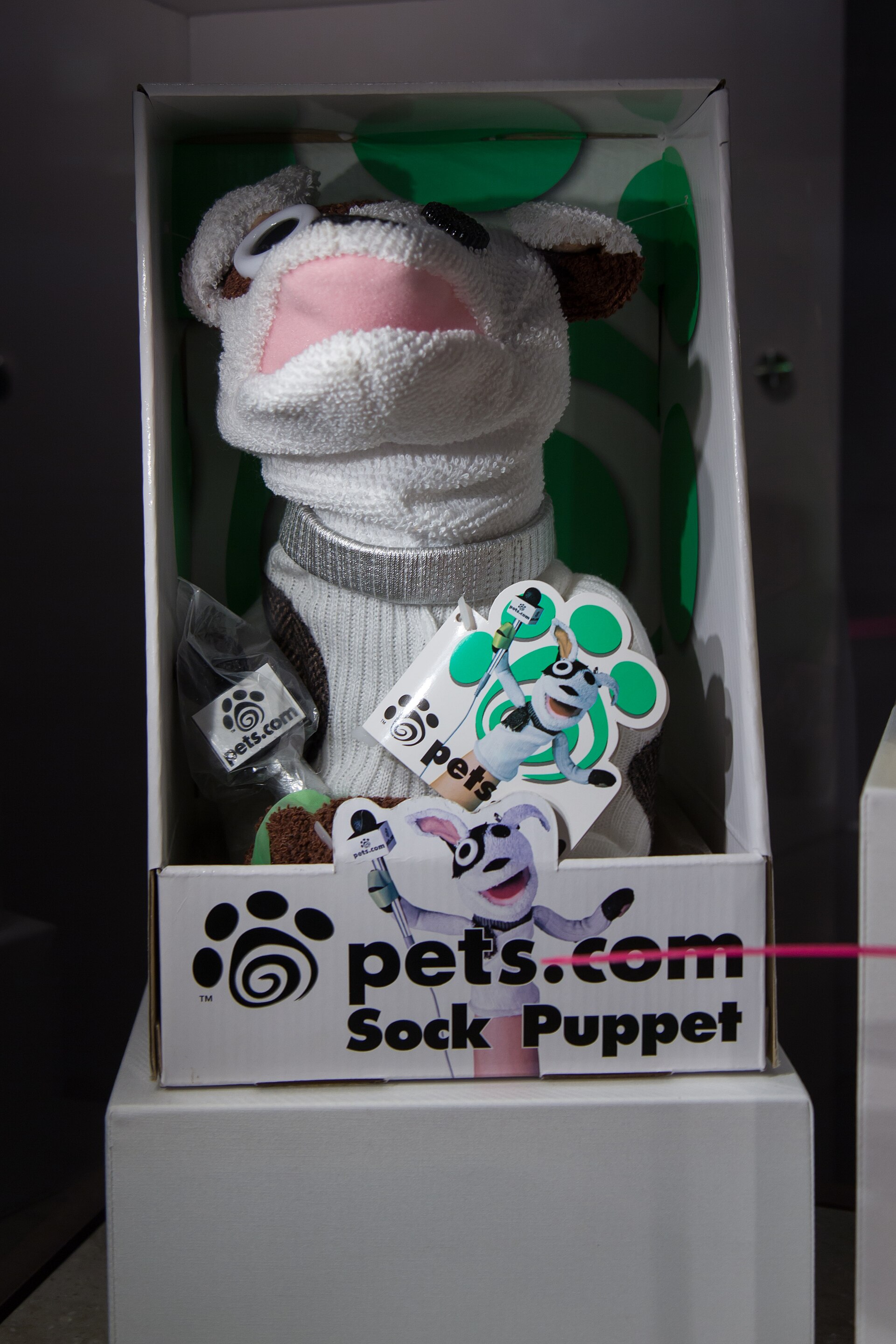 The Pets.com sock-puppet mascot, with its microphone headset, on display at a memorabilia exhibit.
