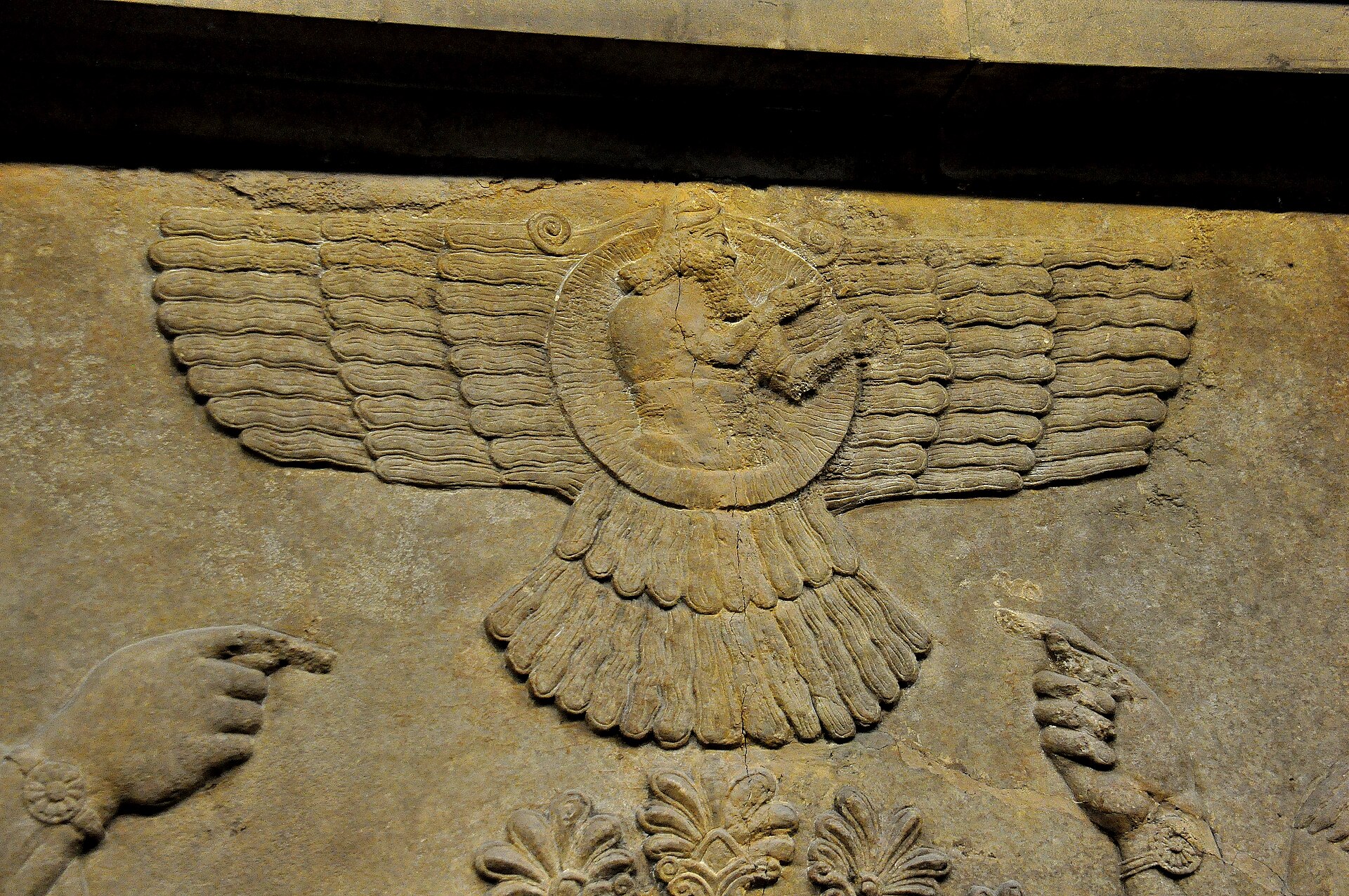 Limestone relief of the god Ashur as an archer within a winged disc, with the worshipping hands of Ashurnasirpal II at right, Neo-Assyrian, 865–850 BCE, British Museum