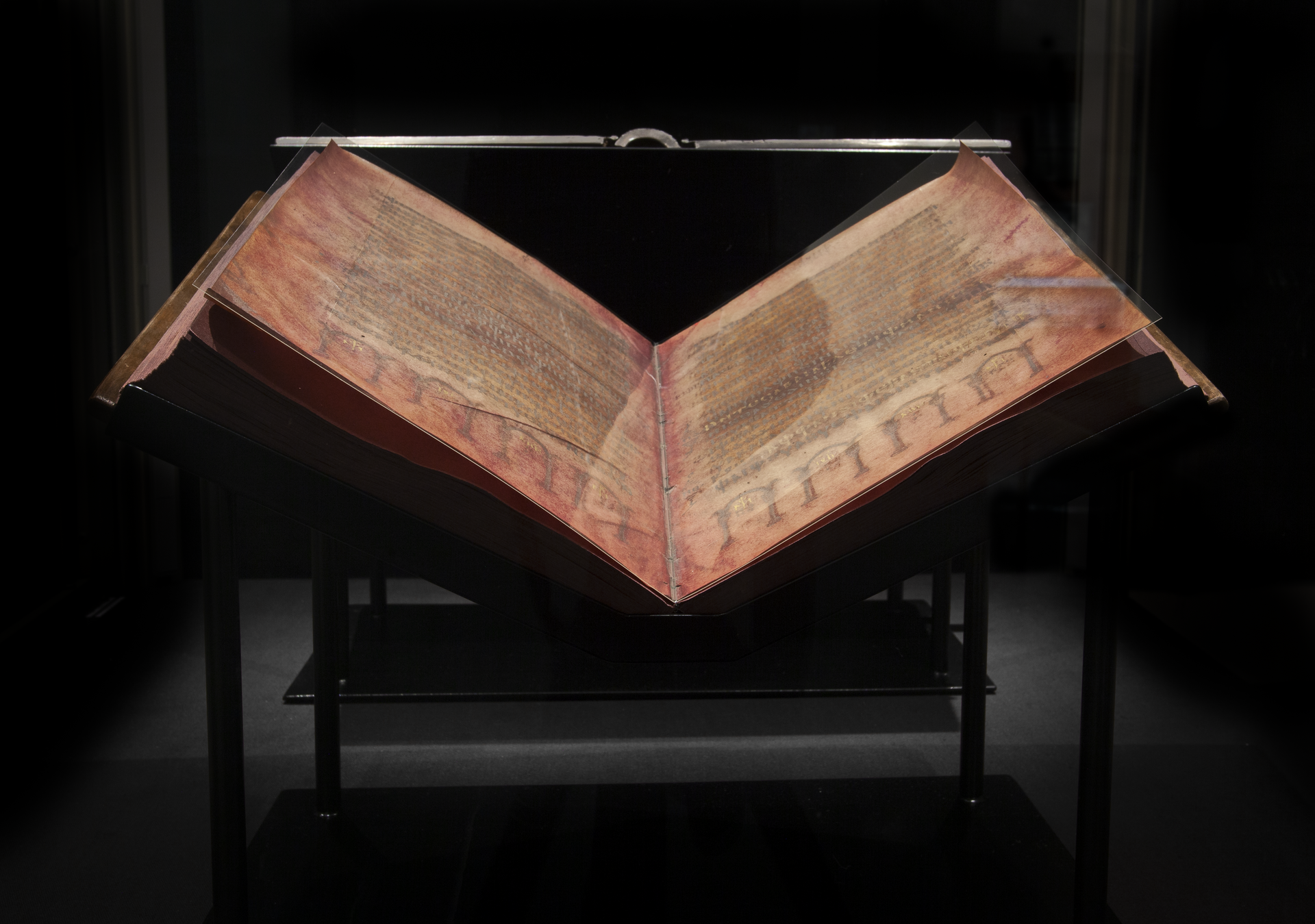 An open spread of the Codex Argenteus, the 6th-century Gothic Bible written in silver ink on purple parchment, Uppsala University Library.