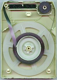 Inside of an 8-track tape cartridge showing the single tape reel mechanism