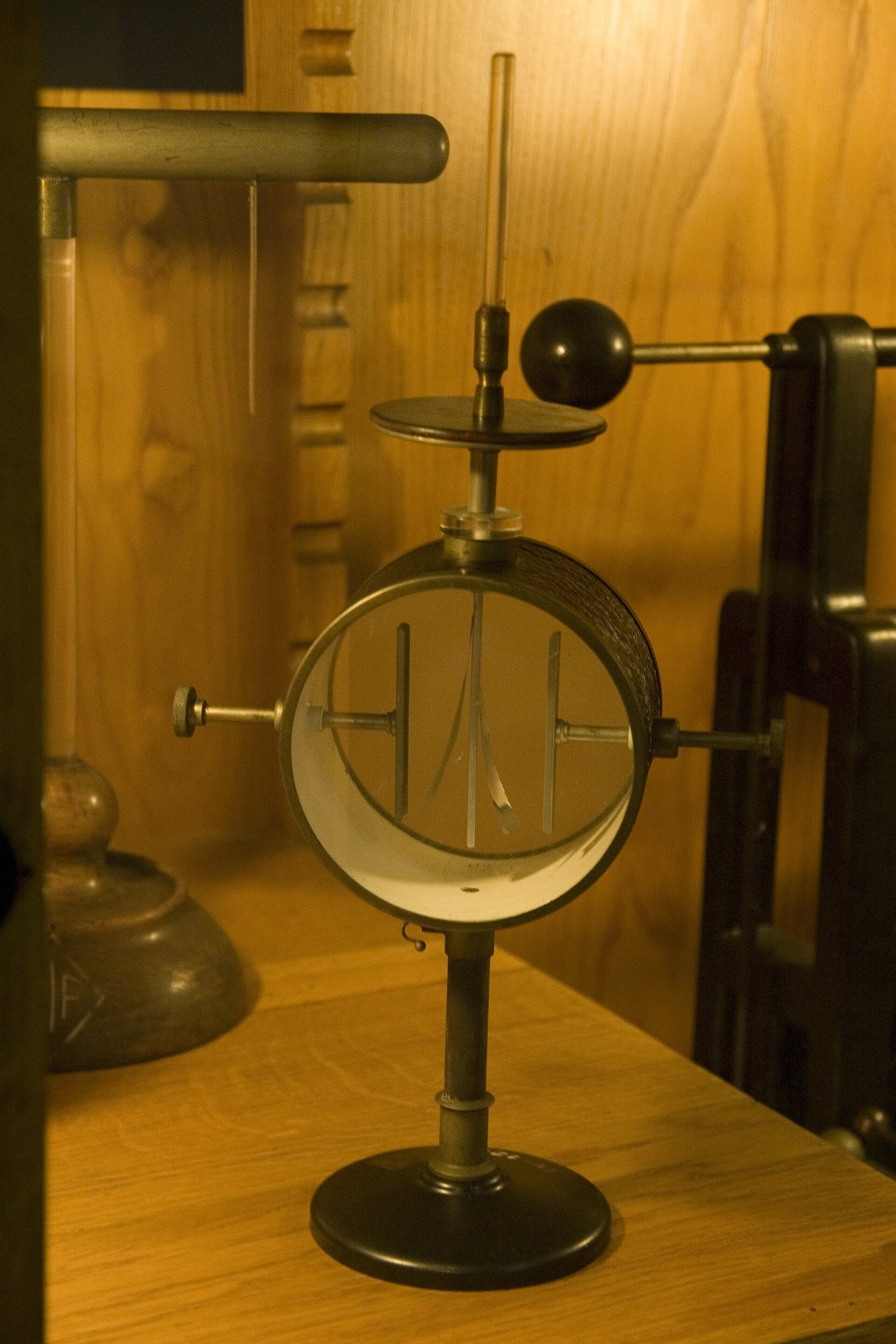 A gold-leaf electroscope in a glass jar, brass rod and terminal disk on top, two gold leaves hanging inside