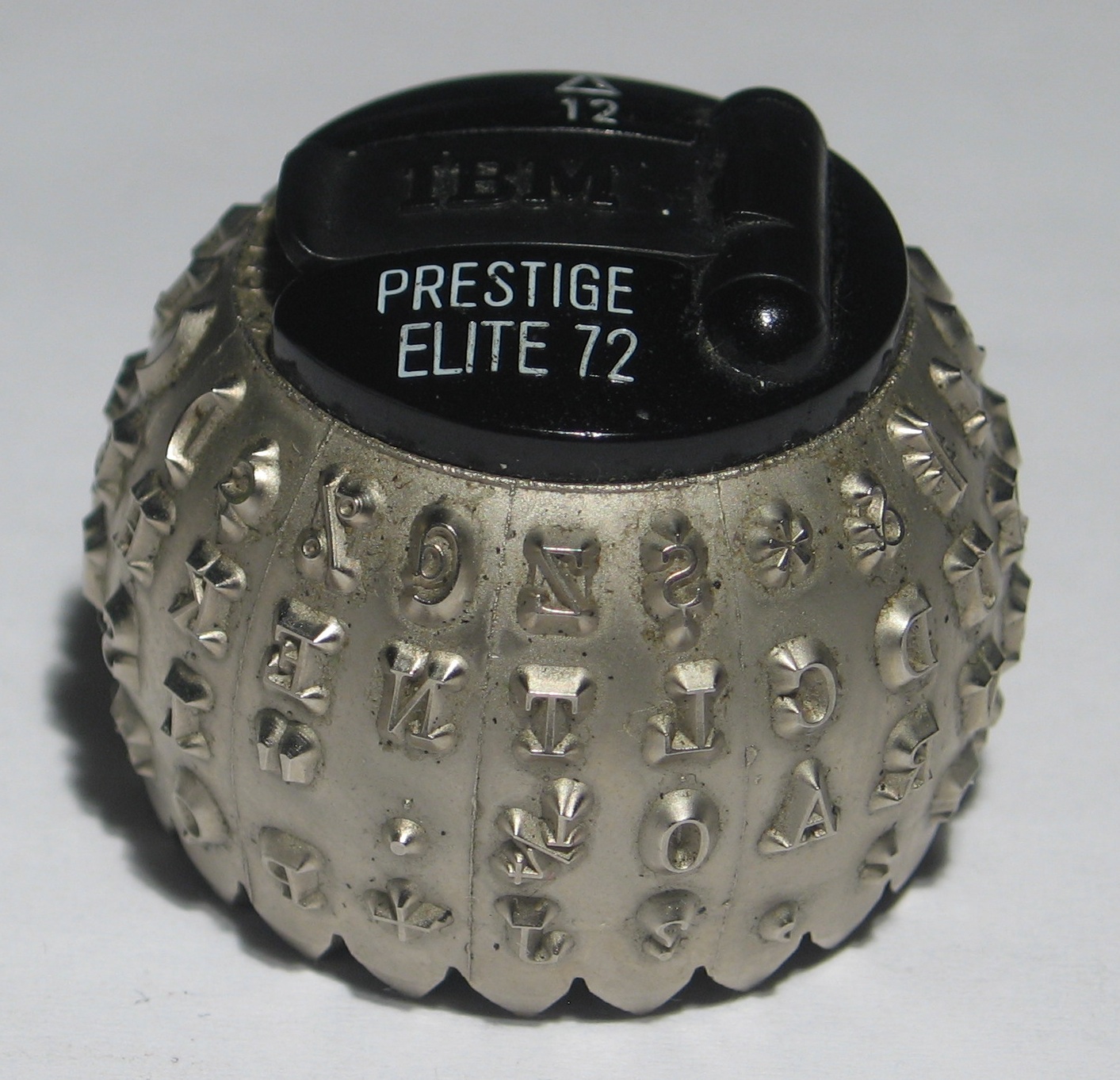 Close-up of an IBM Selectric typeball, the interchangeable spherical type element nicknamed the golf ball