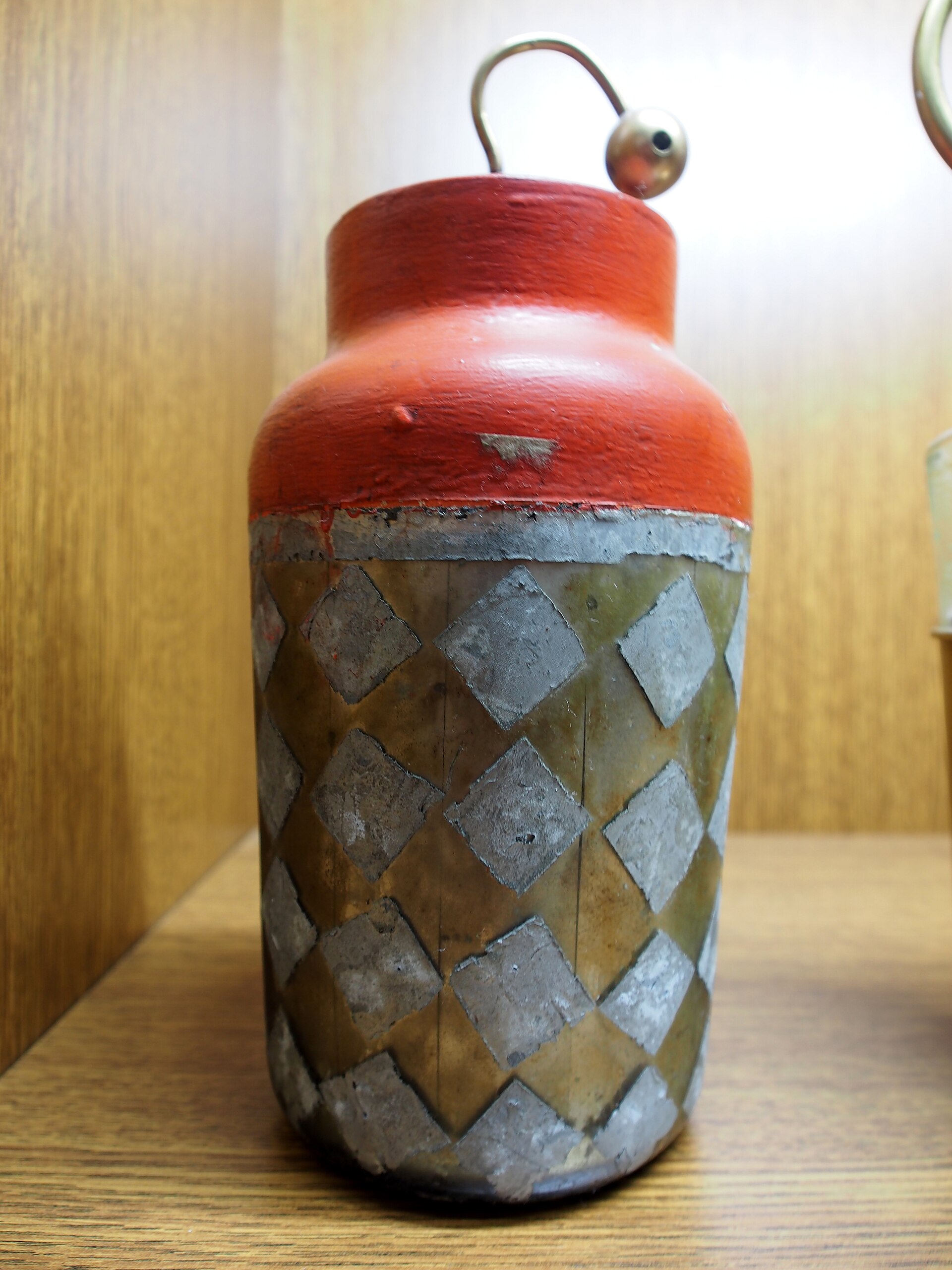 An antique Leyden jar: a glass jar with metal-foil coatings and a central brass rod and chain reaching through the cork