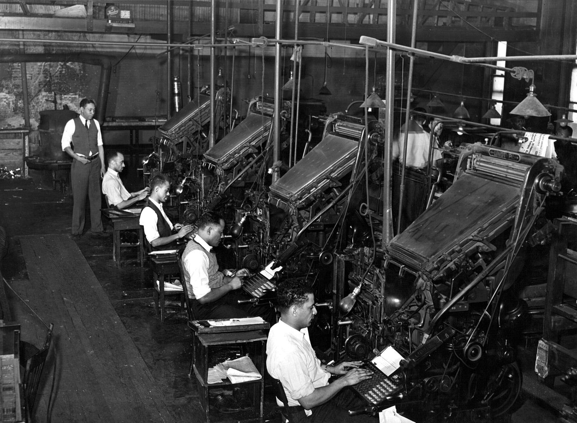 Linotype operators at their keyboards in the composing room of the Chicago Defender newspaper, 1941