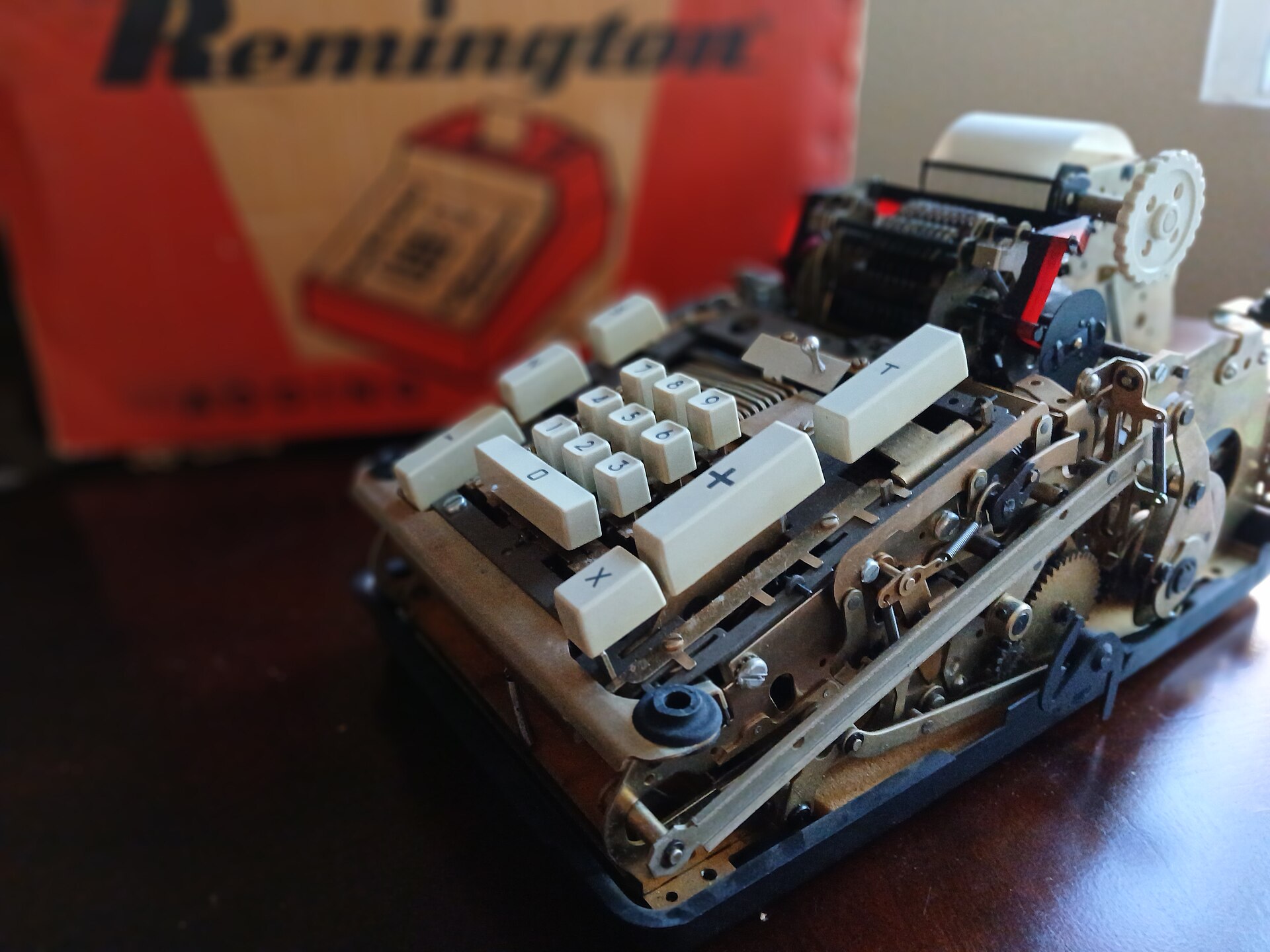 A Remington Model 102 mechanical adding machine with a hand-crank lever, digit keys and a paper register.
