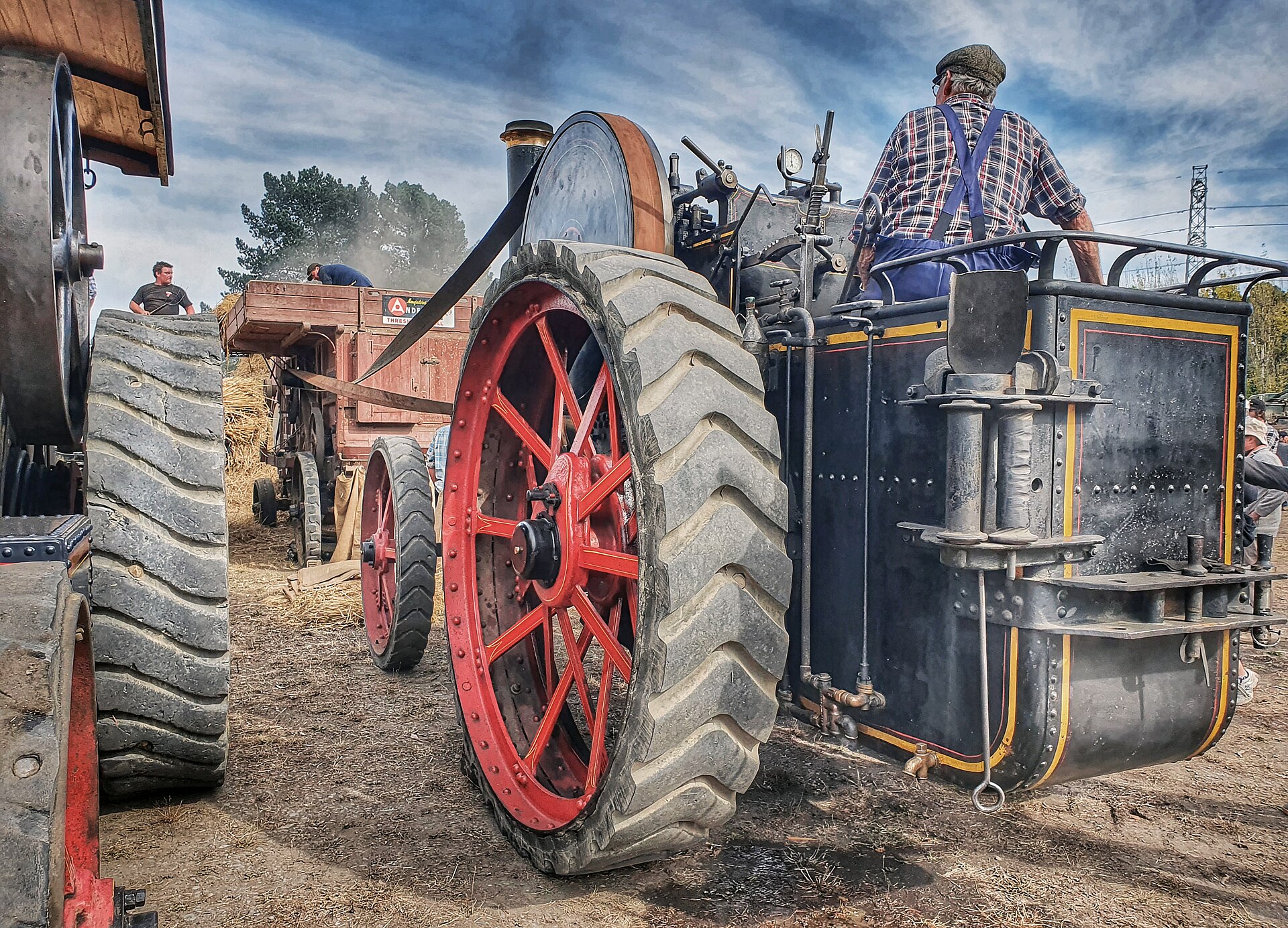 Period photograph of a steam traction engine at work in farming